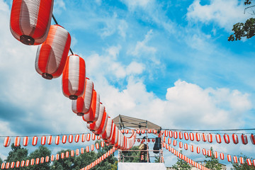 The stage of the Yagura with a big japanese taiko drum Odaiko. Paper red-white lanterns Chochin Scenery for the holiday Obon when people dance of Bon Odori