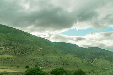 Fototapeta na wymiar Beautiful view of the mountains landscape near Vardzia, Georgia. Mountains, hills, sky with clouds on a summer day
