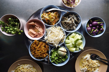 Selection of vegetable and toppings for Nam Ya noodles at a Thai street food stall