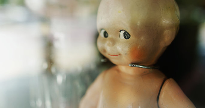 Scary doll behind a window