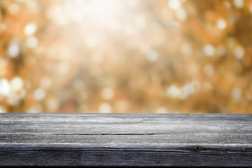Wooden table and blurred bokeh autumn background.