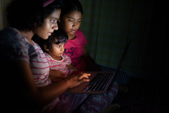 Siblings Watching Video On Laptop