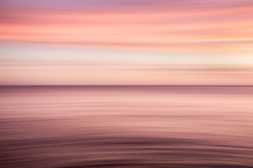 A red and purple blurred seascape background