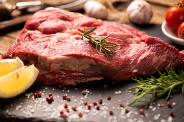 Raw fresh meat on a black cutting board