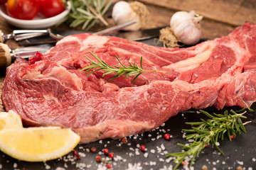 Beefsteak oncutting board over black stone background