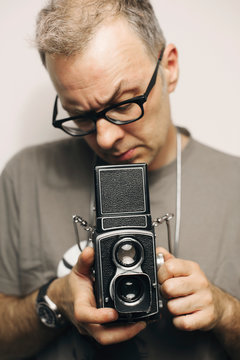 Man holding retro analog camera