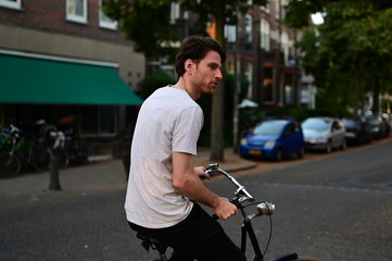 Spontaneous young man riding his bicycle on a scenic street