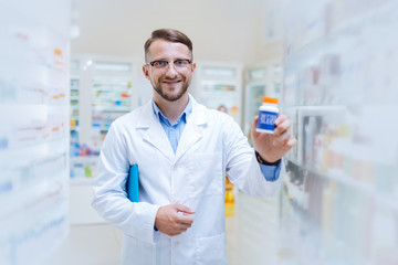 Positive delighted young chemist showing favorite probiotics