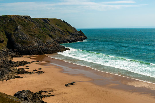 A sandy beach surrounded by cliffs (Pobbles, Gower, Wales)