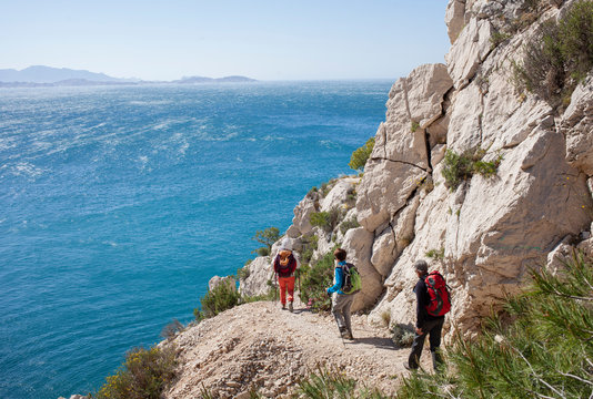 hikers on the edge of mediterranean sea