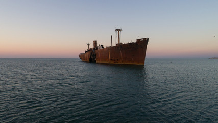 A shipwreck at the black sea shore on a clear morning.
