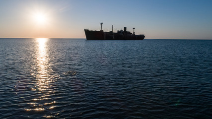 A shipwreck at the black sea shore on a clear morning.