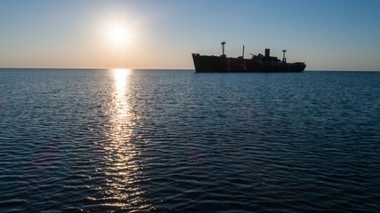 A shipwreck at the black sea shore on a clear morning.