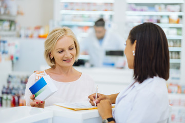 Cheerful female person buying her favorite vitamins