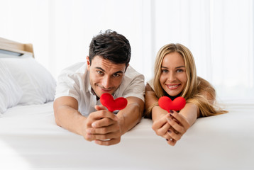 Caucasian couple lover happy smiling and holding red heart in hands