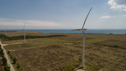 Fototapeta na wymiar Wind mills on the coast line