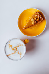 Cup of hot cappuccino coffee with cake