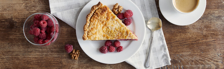 top view of piece of pie and raspberries on wooden table, panoramic shot