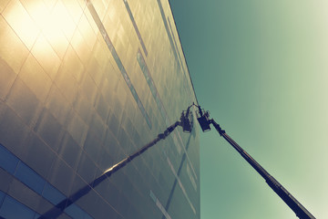 window cleaning of the facade of a modern building with a lift machine