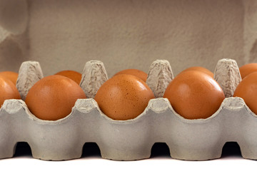 Eggs in paper tray isolated on white background