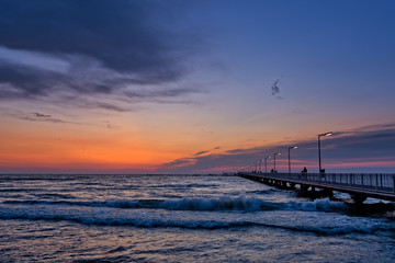 Fototapeta premium Golden sunrise over pontoon bridge with light poles at Black Sea