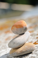small stack of pebbles on a sloping balustrade