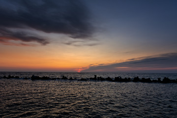 Twilight period before sunrise over the calm sea. Summer sea with blue water and purple sky at the sunset