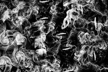Abstract dark background with puffs of white smoke. A lot of smoke on a black background. Art design smoke.