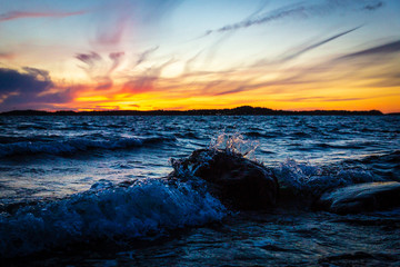 Waves hitting the stones during sunset