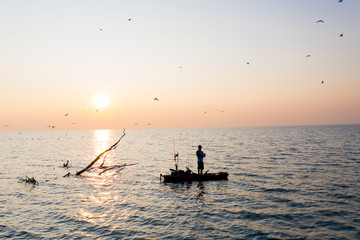 Fototapeta premium Young Man Kayak Fishing at Sunrise in Canada