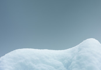 Fototapeta na wymiar snowdrift isolated on gray blue background close-up with copy space