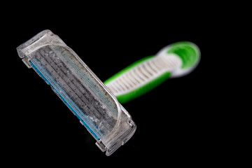 An old used hair shaver. Personal use accessories on a dark table.