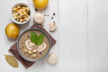mushroom cream soup on white wooden board. Top view