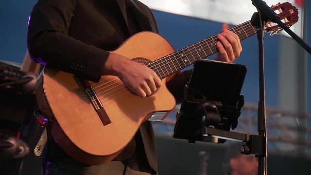 man playing guitar hands close up