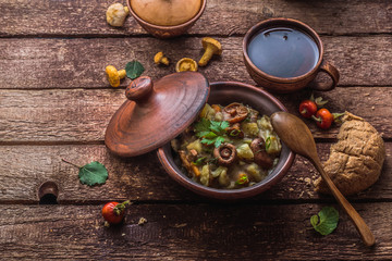 Potato and mushrooms ragout in a pot, copy space