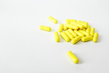 Pink pills on white background