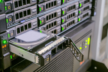 Replacing a hard drive in a powerful web server. Many disk drives are in the computer equipment of...