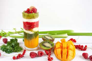 Kolorowe warstwowe smoothie z mango, kiwi, selera naciowego, malin, porzeczek, banana, jarmużu i kremu waniliowego © Monika