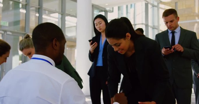  Business people checking in at conference registration table 4k