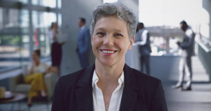Businesswoman looking at camera in the lobby at office 4k