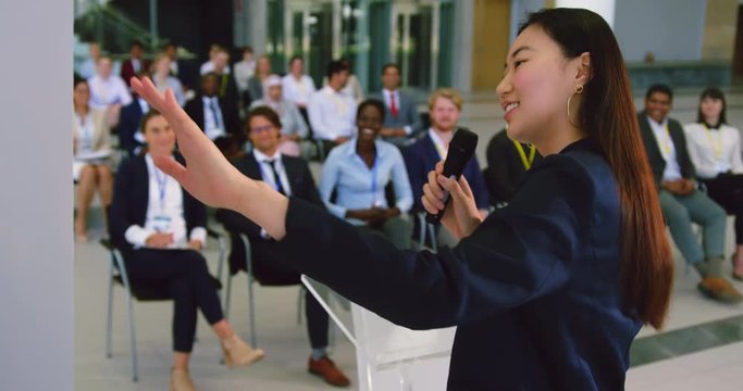 female speaker speaks in a business seminar 4k