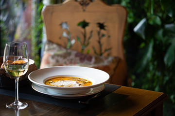 evening in restaurant with wine, pumpkin cream soup and garlic toasts