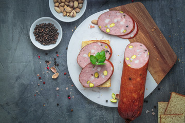 Sandwich with sausage on a marble board. Top view, copy space