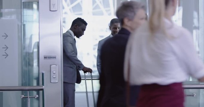 Business people getting in the elevator at modern office 4k
