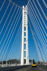 Crossing the new section of the Oakland-San Francisco Bay Bridge under blue sky.