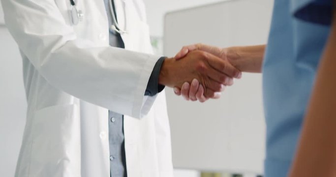 Male and female doctors shaking hands 4k