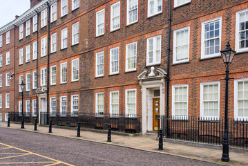 Classic historical apartments Building in Georgian British English style with white windows and red brick wall in central London - 281131162