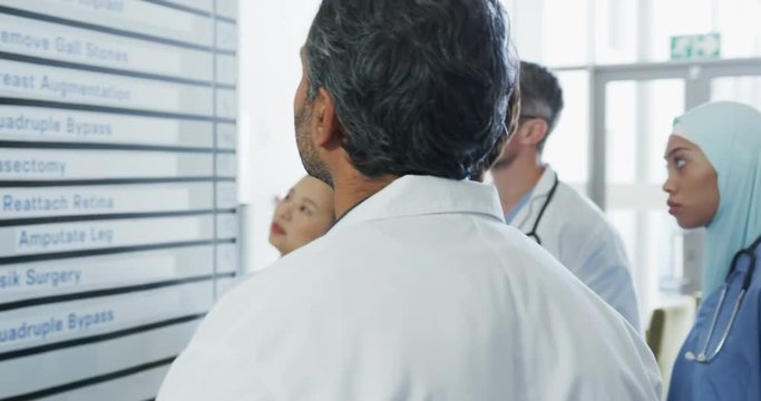 Doctors meeting around a whiteboard 4k