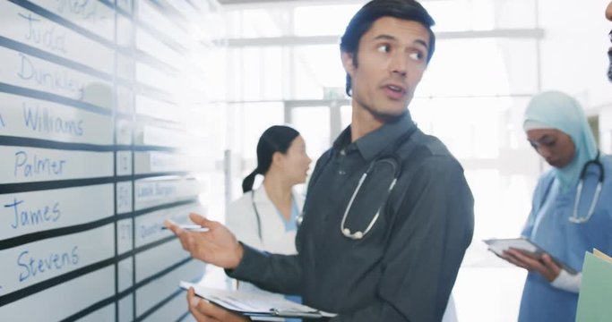 Doctors in discussion at a whiteboard in an office 4k
