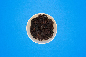 Dried fruits rich in vitamins on a blue background